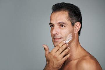 Image showing Man, thinking and studio with face cream, mature male person with skincare and moisturizing lotion. Dermatology, anti aging product with mockup for facial treatment, natural grooming for wellness