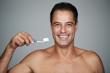 Image showing Man, studio and toothbrush for fresh smile, dental and oral hygiene for mature person. Teeth, breath product with toothpaste and mouth health, whitening and wellness or cleaning for confidence