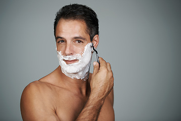 Image showing Shaving cream, portrait and man in studio with razor for epilation or hair removal treatment. Skin, natural and face of mature person with shaver for facial dermatology routine by gray background.