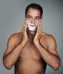 Image showing Man, shaving and foam for beard skincare or after shave with hair removal product, transformation or grey background. Male person, hands and studio wellness or face application, grooming or mockup