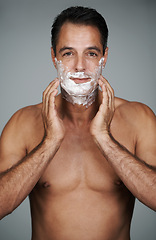 Image showing Man, portrait and shaving cream skincare on beard or after shave with hair removal product, transformation or grey background. Male person, hands and studio or face application, grooming or mockup