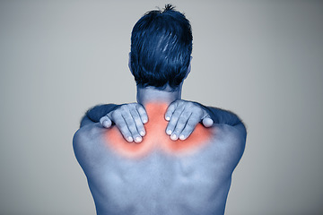 Image showing Studio, man and hands for muscle or shoulder pain with tension or inflammation with discomfort, sprain and stress or strain. Red glow, back view and person with body ache or injury on grey background