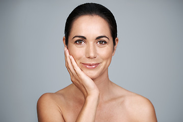 Image showing Mature, skincare and portrait of happy woman touching face with makeup at studio isolated on gray background. Cosmetics, beauty and hand of model in facial treatment for dermatology or anti aging