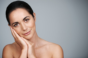 Image showing Portrait, mature and skincare of woman touching face in makeup at studio isolated on gray background. Cosmetics, hands or beauty of model in treatment for dermatology, anti aging and mockup space