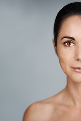 Image showing Woman, studio and portrait with closeup, skin and care for treatment and proud. Model, cosmetics and natural with lip gloss, glow and aesthetic for antiaging confidence isolated on grey background