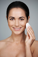 Image showing Woman, pad and beauty in studio, portrait and facial treatment on gray background. Female person, skin care and cotton swab for grooming in daily routine, hygiene and dermatology to remove foundation