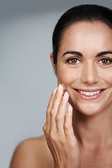 Image showing Smile, face cream and portrait of woman in studio with beauty, natural and anti aging routine. Happy, cosmetic and mature person with spf, lotion or sunscreen for dermatology by gray background.