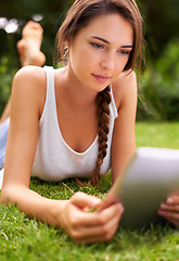 Image showing Backyard, grass and woman relax with tablet, outdoor and garden in home for peace with technology. Summer, nature and girl online with connection to internet to read ebook on app for happiness