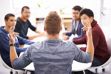 Image showing Creative man, team and meeting with presentation for startup, development or speech at the office. Rear view of speaker talking to group of developers in boardroom or conference for collaboration