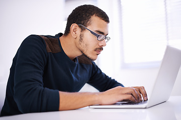 Image showing University, desk and man with laptop for research, study or elearning with education, knowledge and opportunity. Computer, reading and college student writing report for online course with glasses.