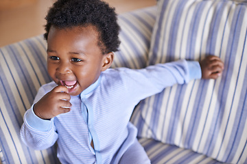 Image showing Baby, smile or sofa as play, fun or game for leisure and playing, growth as relax, learn or humor. Excited, black boy child or laugh as curious confidence for motor skill coordination or development