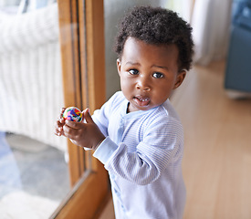 Image showing Baby, portrait and ball playing in home for development growth in apartment for games, wellness or childhood. Black person, kid and face at house window in Kenya at little boy, fun, nursery or health