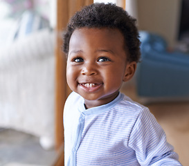 Image showing Baby, smile or teeth in childcare, health or growth in play, leisure and relaxation in living room. Happy, black boy or child as curious, playful or fun in motor skill or childhood development