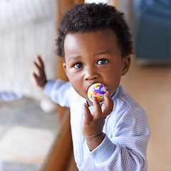 Image showing Portrait, baby or toy in play, coordination or growth as learning, game or progress in Jamaica. Black boy, child or ball in mouth as healthy, motor skill or fun in curious, cognitive or sensory