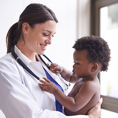 Image showing Happy, pediatrician and woman with baby, boy and checkup with stethoscope and doctor in clinic. Medical, professional and employee with healthcare or infant with appointment or medicare with wellness