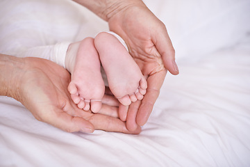 Image showing Baby, feet and hands for childcare on bed or development with parenting trust with support, love or connection. Kid, foot and fingers in palm for wellness bonding in apartment, protection or security