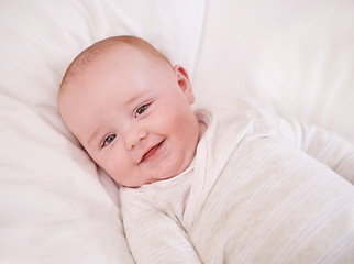 Image showing Baby, portrait and smile on bed for relax comfort in family home for childhood development for growth, morning or care. Kid, boy and face on linen bedding in apartment with happiness, love or calm