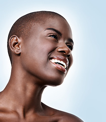 Image showing Black woman, smile or thinking of beauty, skincare, natural makeup or healthy shine isolated in studio. Dermatology ideas, bald head and happy African model with glow or results on blue background