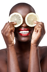 Image showing Black woman, smile and lemon skincare in studio in organic dermatology routine or wellness. White background, face and happy African model with facial fruit, diet food and eyes product for beauty