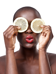 Image showing Black woman, kiss and lemon skincare in studio for organic dermatology routine, youth or wellness. White background, face and African model with facial fruit, diet food and eyes product for beauty