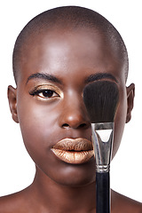 Image showing Portrait of black woman, brush or makeup with lipstick, cosmetics or beauty isolated in studio. Gold color, bald head or serious African girl model with glow or skincare results on white background