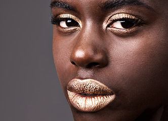 Image showing Portrait, beauty and closeup for cosmetic, black woman person and lipstick on grey background. Face, gold and eyeshadow for female model from Nigeria, natural and skincare with confidence in studio