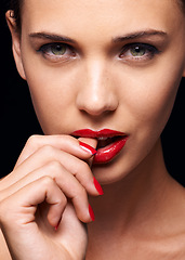 Image showing Beauty, makeup and portrait of woman for skincare in studio with manicure on hand isolated on a black background. Cosmetics, model and face of person with red lipstick on mouth, serious or bite thumb