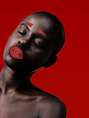 Image showing Black woman, makeup and artistic with red, skin and creative with studio and color. Model, closeup and face paint for cosmetics, contrast and aesthetic for glamour isolated on background for beauty