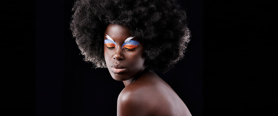 Image showing African woman, makeup and eyeshadow with beauty, skin and creative with studio and color. Model, closeup and face paint for artistic, contrast and aesthetic for glamour isolated on black background