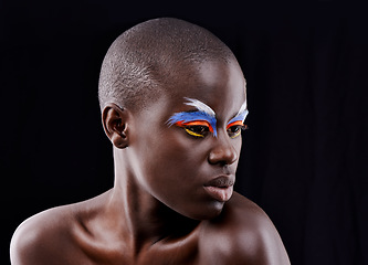 Image showing African model, makeup and eyeshadow with beauty, skin and creative with studio and color. Woman, closeup and face paint for artistic, contrast and aesthetic for glamour isolated on black background