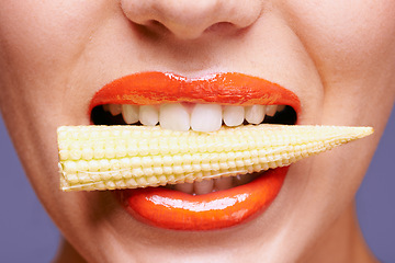 Image showing Woman, lipstick and vegetable in mouth for beauty, nutrition and healthy with vegan cosmetic product in studio. Cruelty free makeup, cosmetology and baby corn, orange lip gloss for aesthetic or art