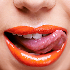 Image showing Beauty, lipstick and mouth of woman with tongue out, makeup and closeup of shiny cosmetic product with skin. Lick, flirting and orange lip gloss for aesthetic with cosmetology, glow and bold color