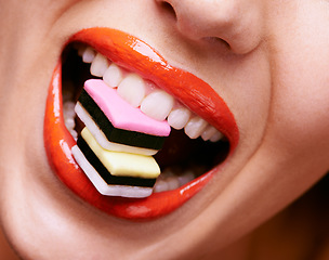 Image showing Beauty, lipstick and woman with candy in mouth, makeup and creativity with closeup of shiny cosmetic product. Licorice, sweets and orange lip gloss for aesthetic, art and cosmetology with glamour