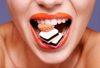 Image showing Makeup, lipstick and woman with sweets in mouth, beauty and creativity with closeup of shiny cosmetic product. Licorice, candy and orange lip gloss for aesthetic, art and cosmetology with glamour