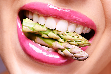 Image showing Woman, lipstick and closeup of vegetable in mouth for beauty, nutrition and healthy with vegan cosmetic product. Cruelty free makeup, cosmetology and asparagus, pink lip gloss for aesthetic or art