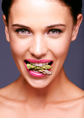 Image showing Woman face, lipstick and vegetable in mouth for beauty, nutrition and vegan cosmetic product. Cruelty free makeup, portrait and asparagus with pink lip gloss for aesthetic on purple background