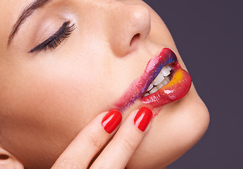 Image showing Lipstick, smear and woman with makeup and hand, beauty and red nail polish with cosmetic product in studio. Face, smudge on skin and color for cosmetology with manicure and art on purple background