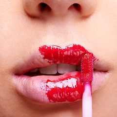 Image showing Beauty, mouth and woman with brush for lipstick, red makeup application and closeup of shiny cosmetic product. Face, skin and cosmetology with change or transformation, glamour and bold lip gloss