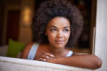 Image showing Woman, smile and thinking for relax and happy in home or indoor on weekend and alone on break and joyful. African person and attractive for peace, rest or chill in living room or house on sofa