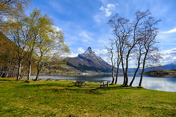 Image showing Serene lakefront picnic spot with majestic mountain view in earl