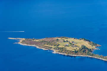 Image showing Serene islet embraced by azure waters witnessed from above on a 