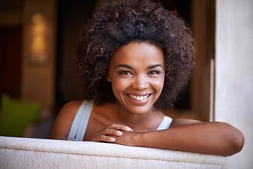 Image showing Happy, woman and portrait on sofa in living room for weekend rest, break or stress free afternoon. Smile, relax and face of black female person on couch with enjoyment, satisfaction and comfort