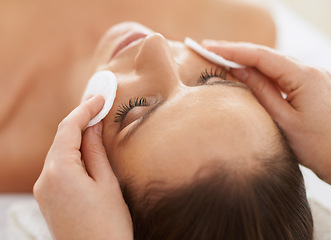 Image showing Woman, cotton and facial massage for organic treatment to relax, cosmetics and beauty therapy for skin care. Female person, calm and serene or dermatology, closeup and rest at hotel and peace or zen