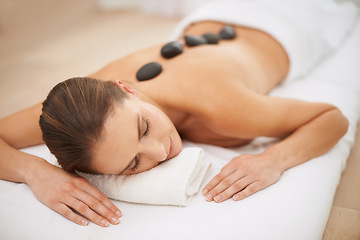 Image showing Relax, stone massage and woman at spa for health, zen wellness and luxury holistic treatment. Self care, peace and girl with natural body therapy, comfort and calm pamper service at hotel for detox