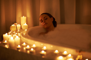 Image showing Woman, bathtub and candles for relax treatment at spa or cleaning routine with bubbles for washing, hygiene or wellness. Female person, calming and stress relief skincare with peace, tub or comfort