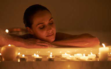 Image showing Woman, bathtub and candles for spa care with relax cleaning routine with bubbles for treatment, hygiene or wellness. Female person, calm and stress relief skincare with peace resting, tub or comfort