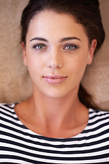 Image showing Woman, portrait and home to relax on couch, chill and smile while lazy or comfortable in lounge. Female person, happy and resting on sofa in living room, closeup and mindfulness or calm confidence