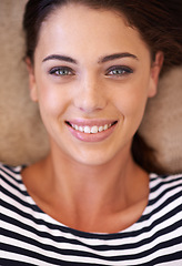 Image showing Woman, portrait and smile on floor, above and pride with closeup, relax and home in living room. Girl, person and happy in headshot on carpet with fashion for morning in lounge in apartment in Italy