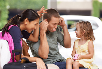 Image showing Travel, suitcase and family in a city street for hitchhiking, road trip or bonding with funny face games. Love, journey or kid with playful parents outdoor for adventure, vacation or waiting for taxi