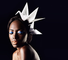 Image showing Studio, beauty and cosmetics for black woman with origami in dark background with aesthetic for luxury. Eyeshadow, glow and foundation on face of girl for shine, African female person and makeup